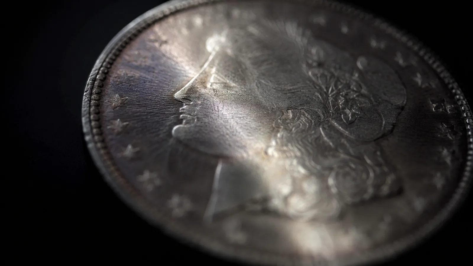 Morgan silver dollar obverse in dramatic macro lighting